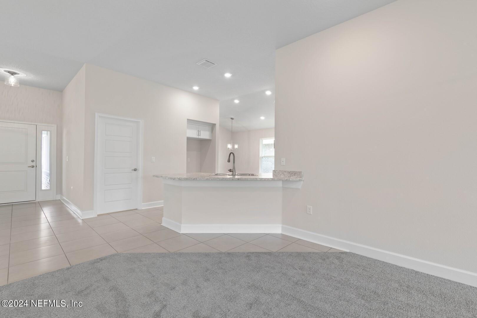 70 Rivertown Road Palm Coast, FL 32137 - Photo 9 of 25 a view of kitchen and empty room