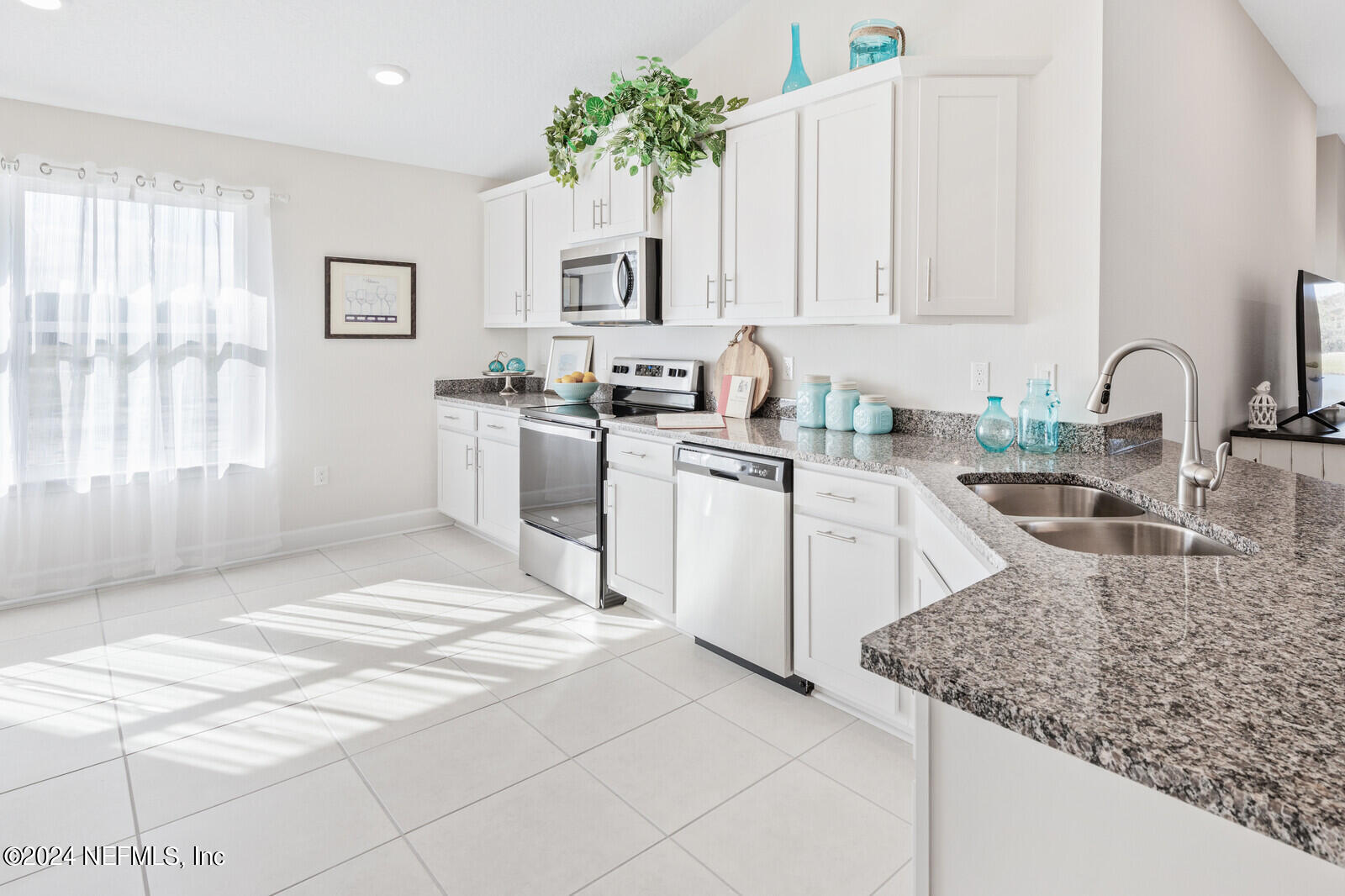 70 Rivertown Road Palm Coast, FL 32137 - Photo 10 of 25 a kitchen with stainless steel appliances granite countertop a sink stove and cabinets
