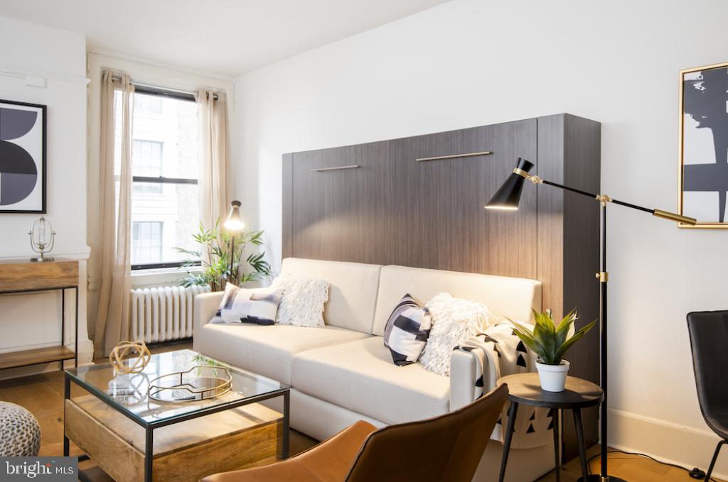 1229 Chestnut Street, Unit 702 Philadelphia, PA 19107 - Photo 2 of 21 a living room with furniture and a potted plant