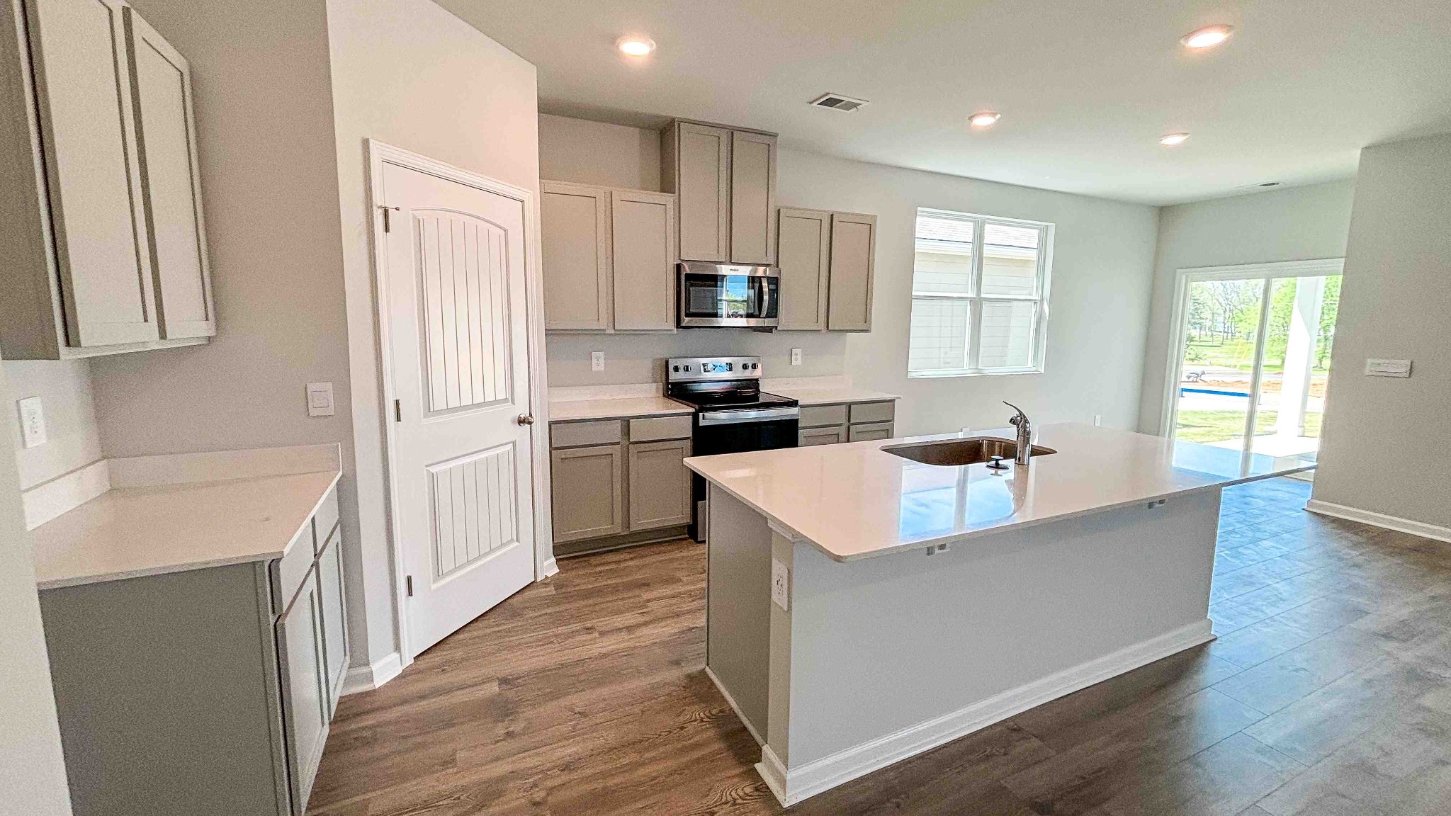 301 Harvest Point Boulevard Spring Hill, TN 37174 - Photo 11 of 25 a kitchen with stainless steel appliances granite countertop a sink stove and refrigerator