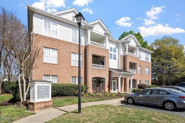 a front view of a residential apartment building with a yard