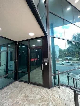 a view of a porch with a table and chairs