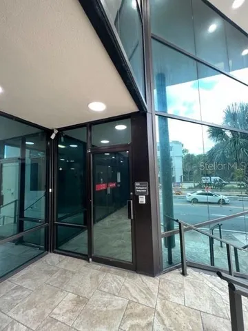 a view of a porch with a table and chairs