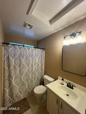 a bathroom with a sink and mirror with toilet