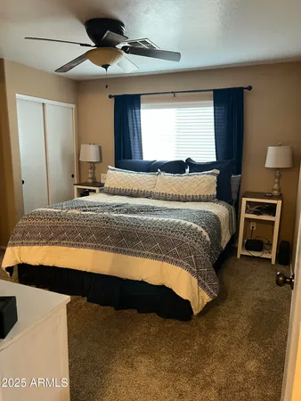 a bedroom with a bed and a night stand