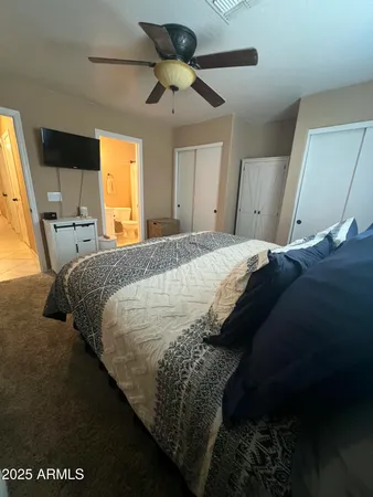 a bed sitting in a bedroom next to a window