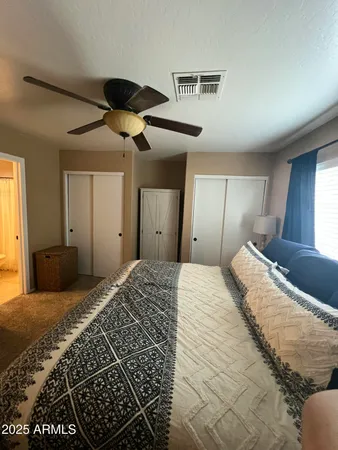 a bedroom with bed and a chandelier