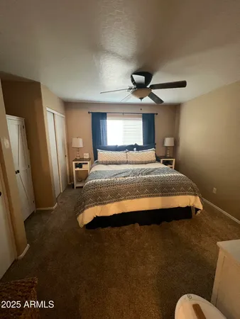a bedroom with a bed and a large mirror