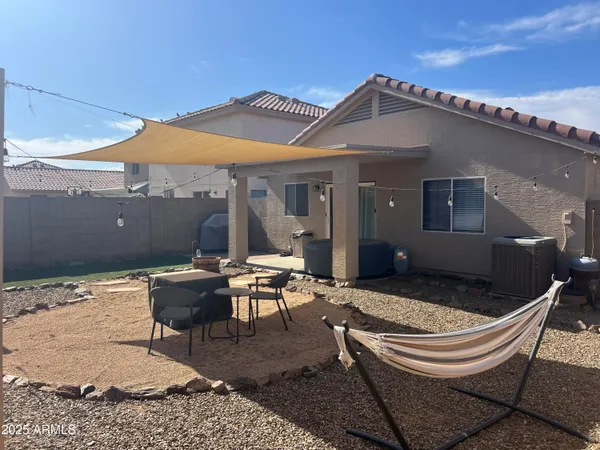 a backyard of a house with outdoor seating