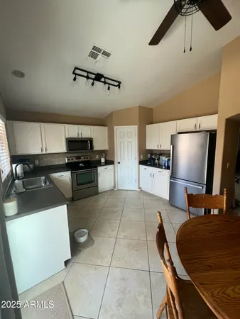 a kitchen with a sink stainless steel appliances and cabinets