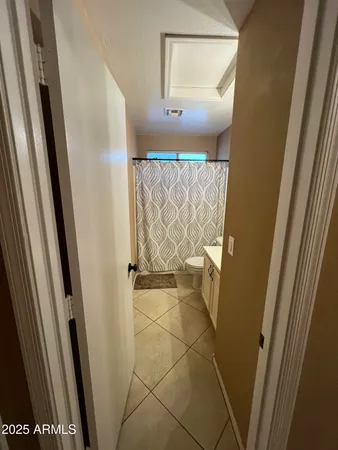 a view of walk in closet with empty space and door
