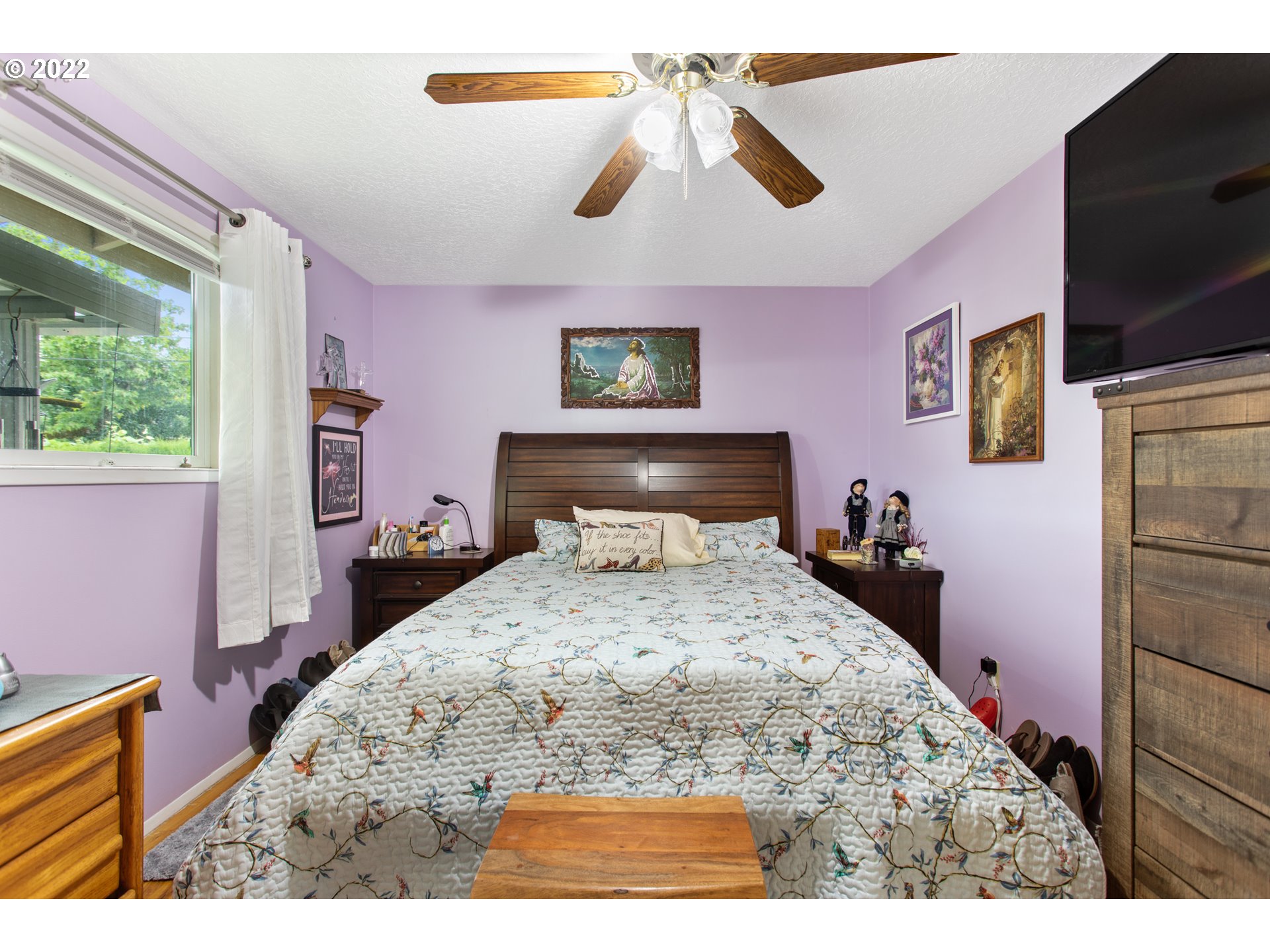 1740 Jansen Way Woodburn, OR 97071 - Photo 11 of 30 a bedroom with a bed and a chandelier