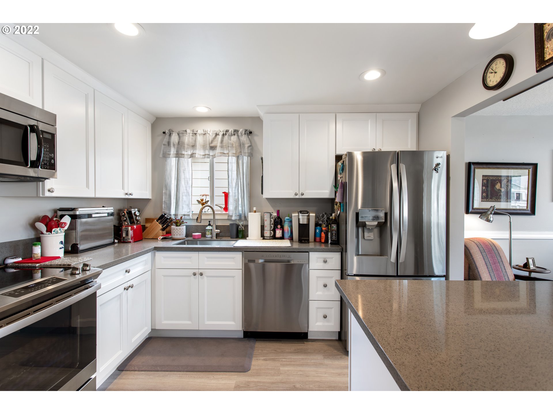 1740 Jansen Way Woodburn, OR 97071 - Photo 8 of 30 a kitchen with stainless steel appliances granite countertop a refrigerator sink and stove