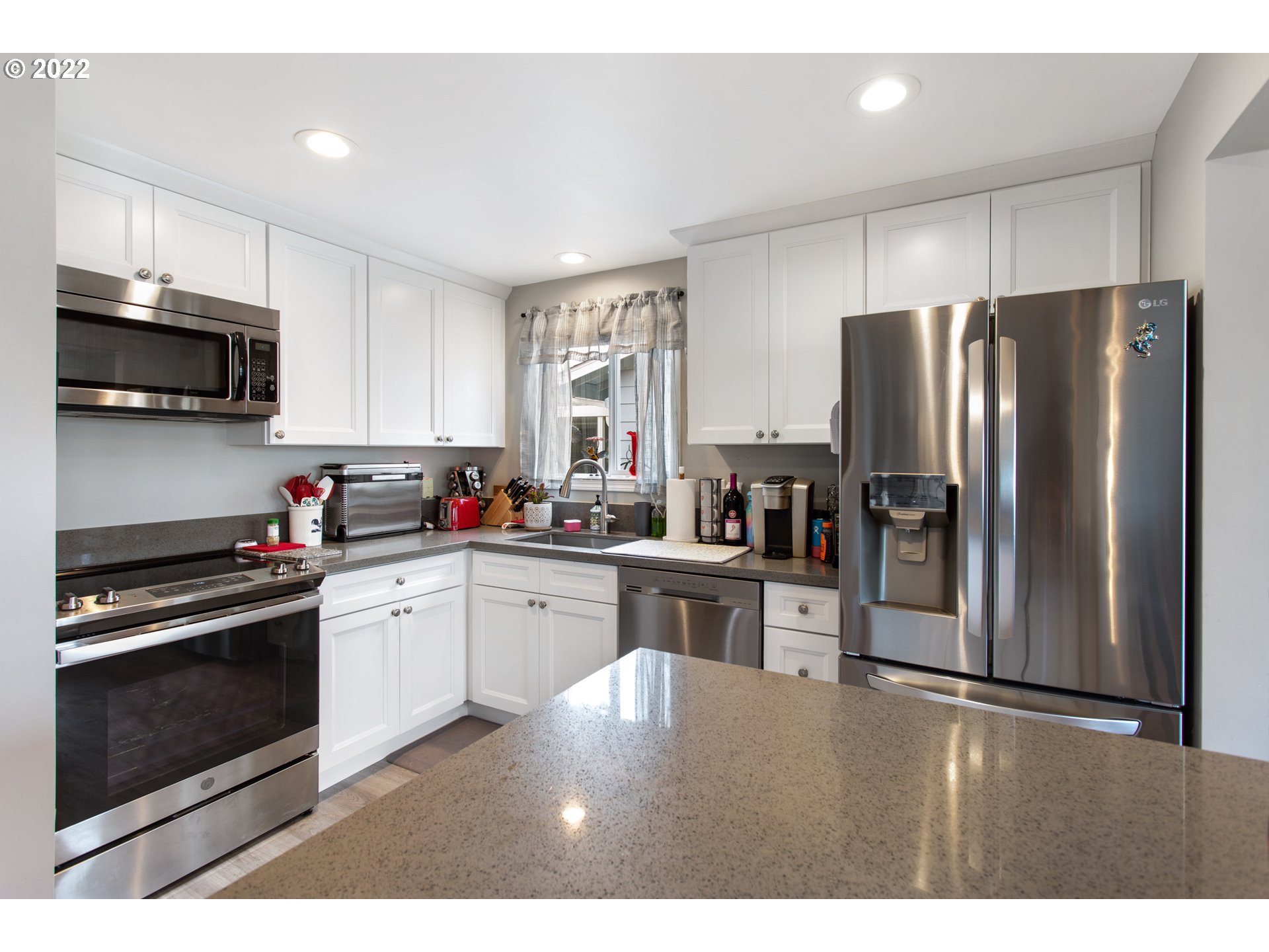 1740 Jansen Way Woodburn, OR 97071 - Photo 9 of 30 a kitchen with granite countertop a refrigerator a stove a microwave a sink dishwasher and wooden cabinets