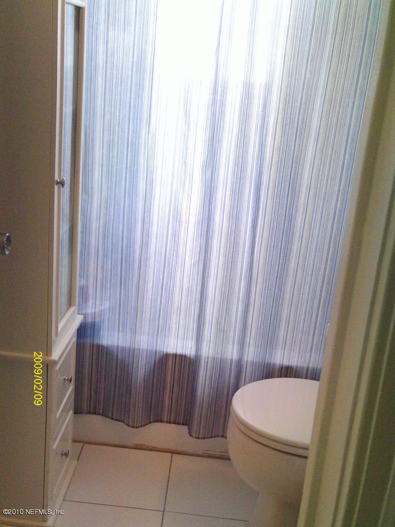 2045 Kingswood Road Jacksonville, FL 32207 - Photo 13 of 22 a bathroom with a toilet and shower
