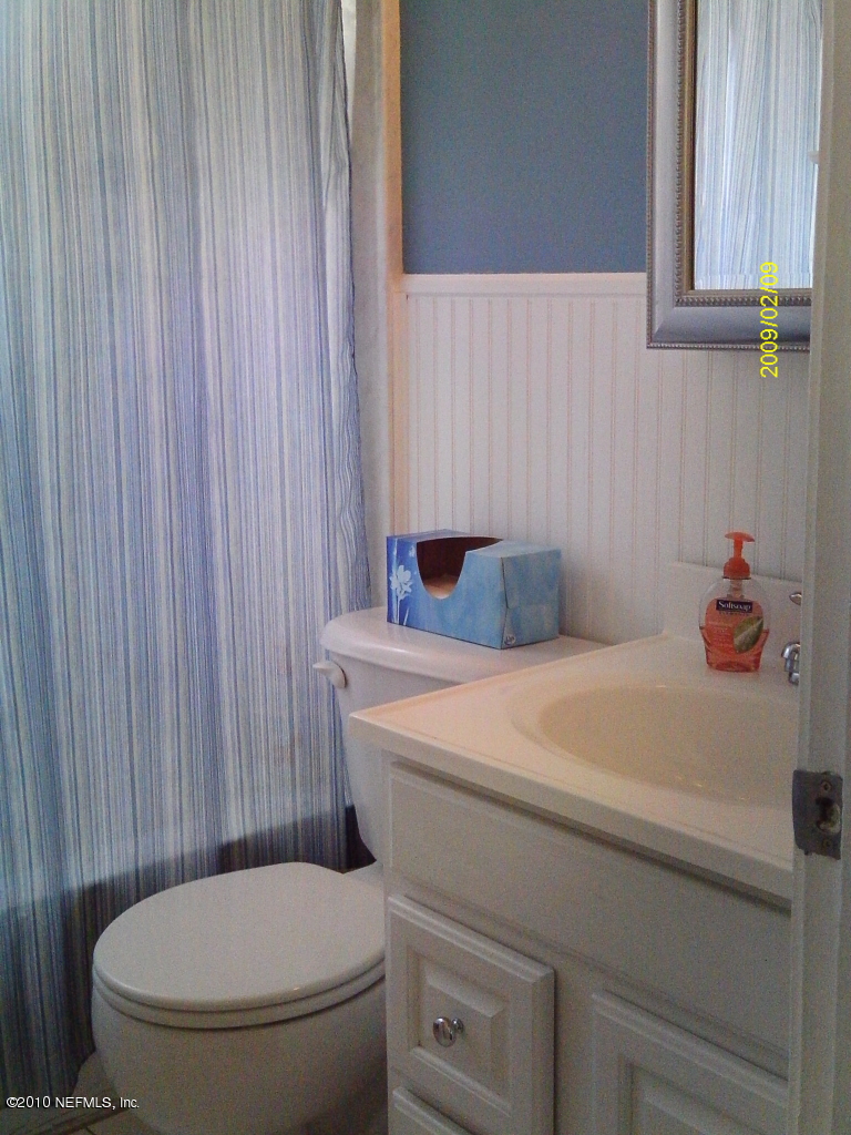 2045 Kingswood Road Jacksonville, FL 32207 - Photo 14 of 22 a bathroom with a toilet and a shower curtain