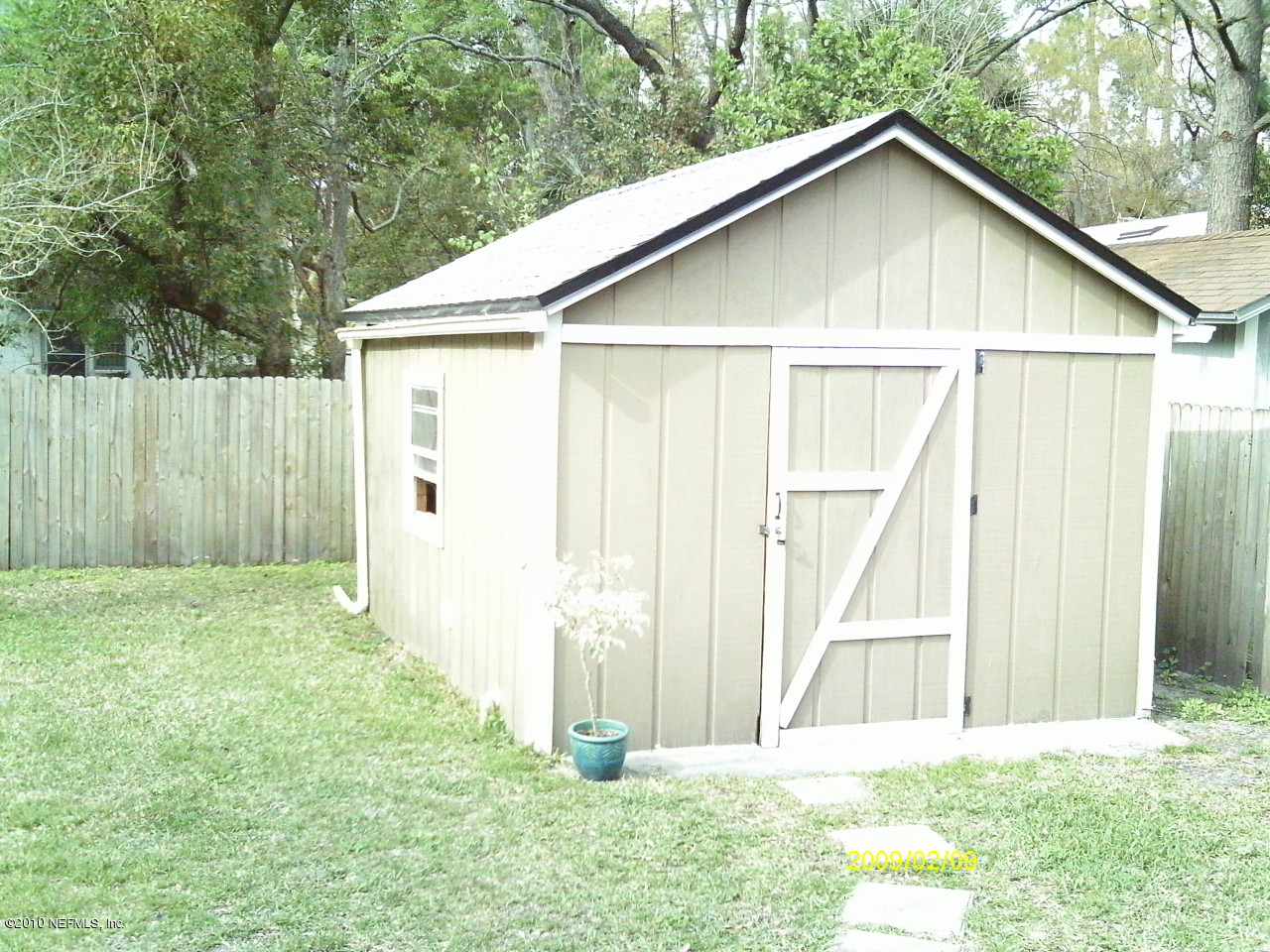 2045 Kingswood Road Jacksonville, FL 32207 - Photo 17 of 22 a view of backyard with small cabin and wooden fence
