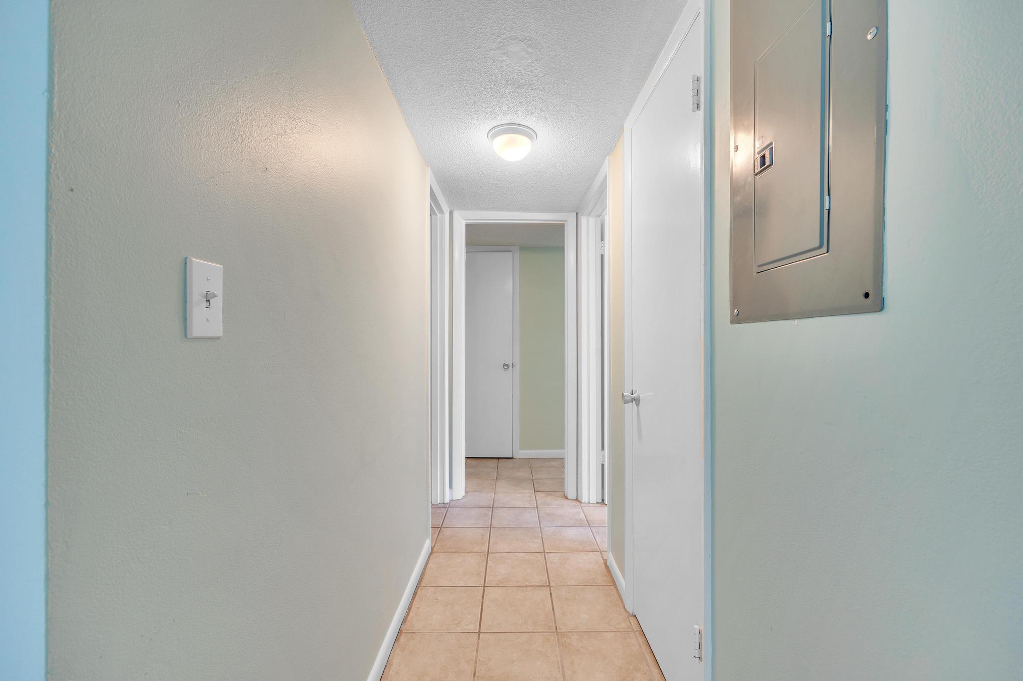1129 Pebble Beach Lane, Unit 6 Marathon, FL 33050 - Photo 12 of 32 a view of a hallway with wooden floor