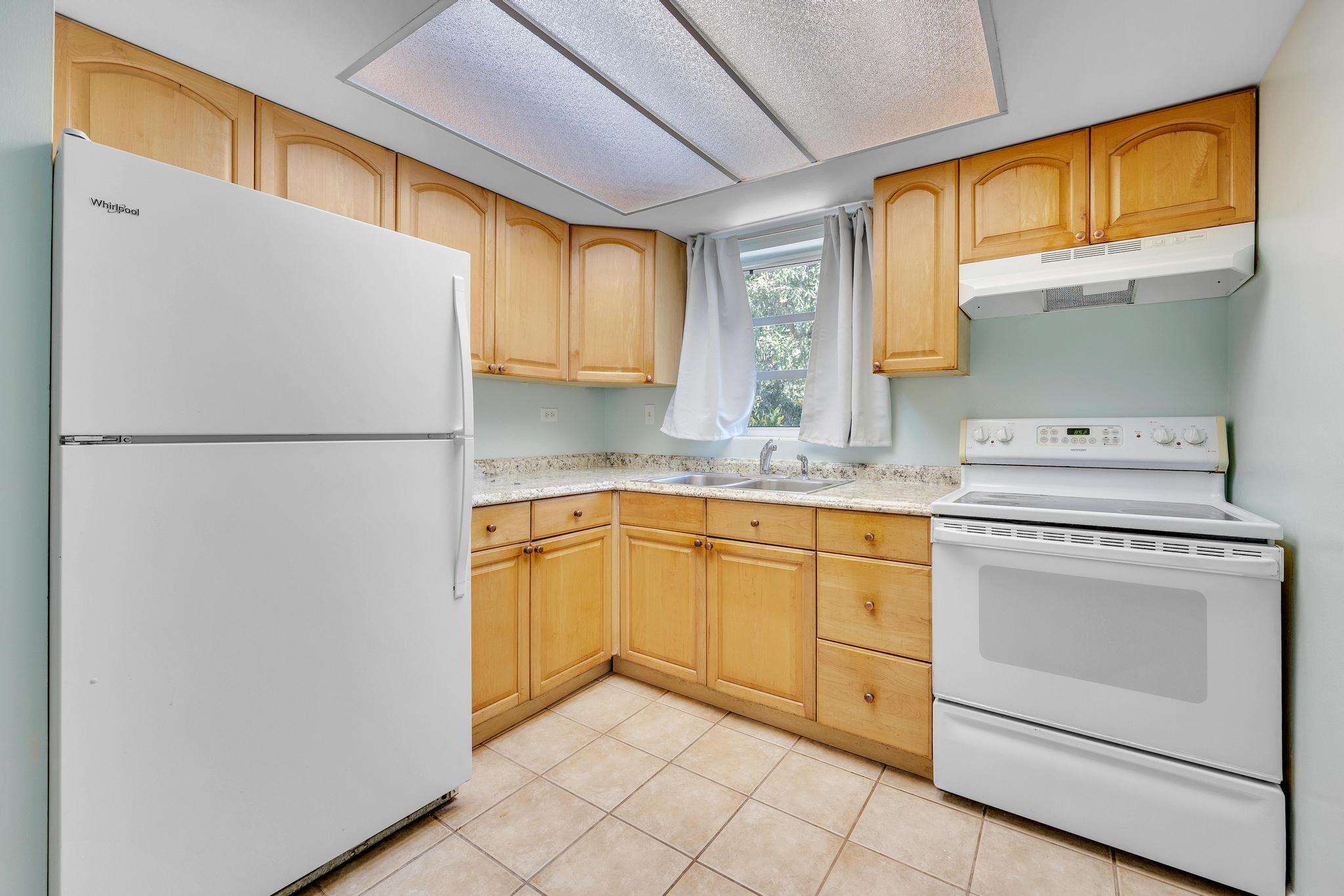 1129 Pebble Beach Lane, Unit 6 Marathon, FL 33050 - Photo 5 of 32 a kitchen with appliances cabinets and a sink