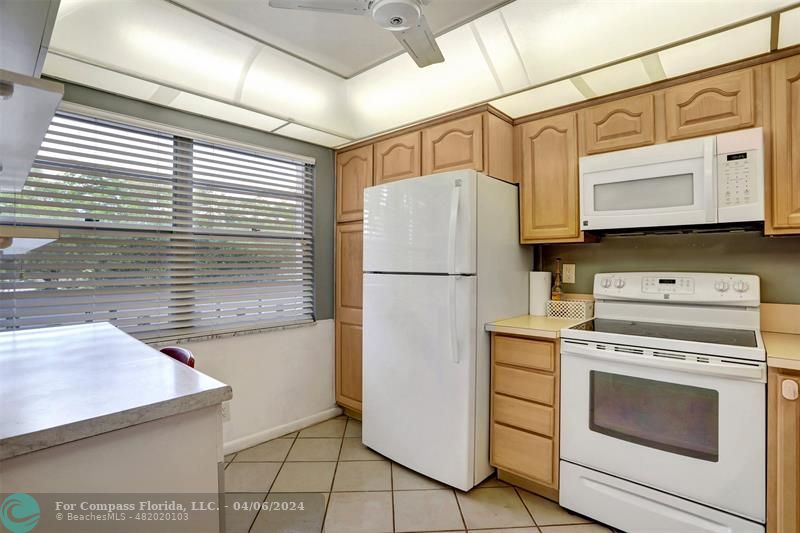 a kitchen with a stove cabinets and a refrigerator