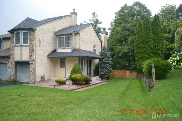 a view of a house with a yard and plants