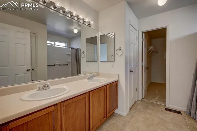 a bathroom with a sink double vanity and a mirror