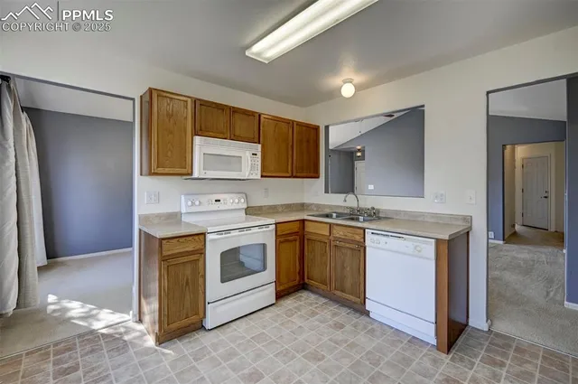 a kitchen with stainless steel appliances granite countertop a sink and a stove