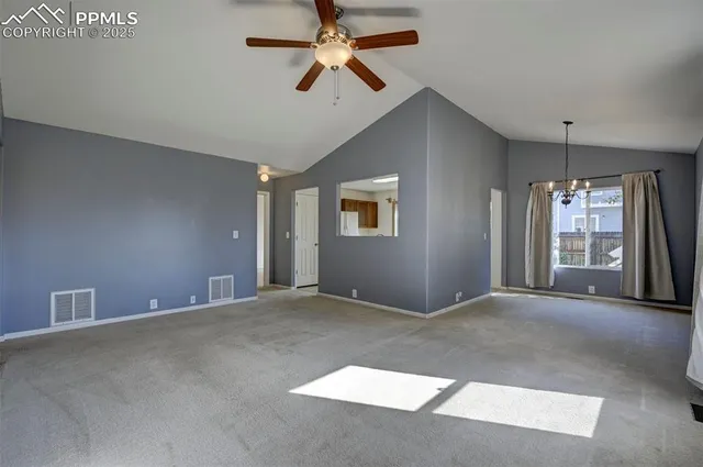 a view of an empty room with a ceiling fan