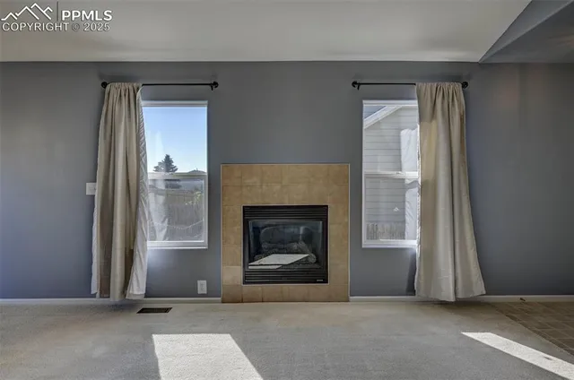 a living room with a fireplace and a window