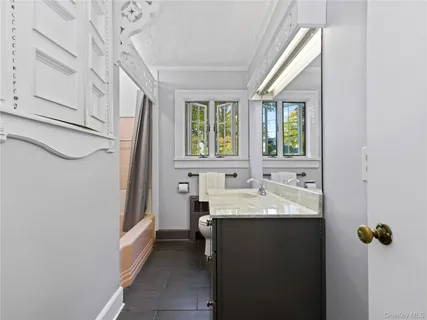 a bathroom with a sink a mirror and a bathtub