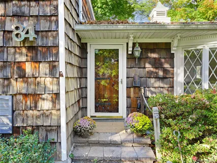a front view of a building with a garden