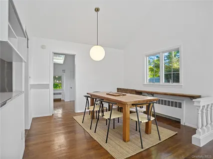 a view of a dining room with furniture window and wooden floor