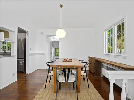a view of a dining room with furniture window and wooden floor