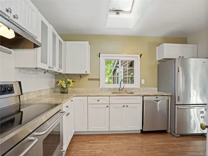 a kitchen with a sink a refrigerator and a stove