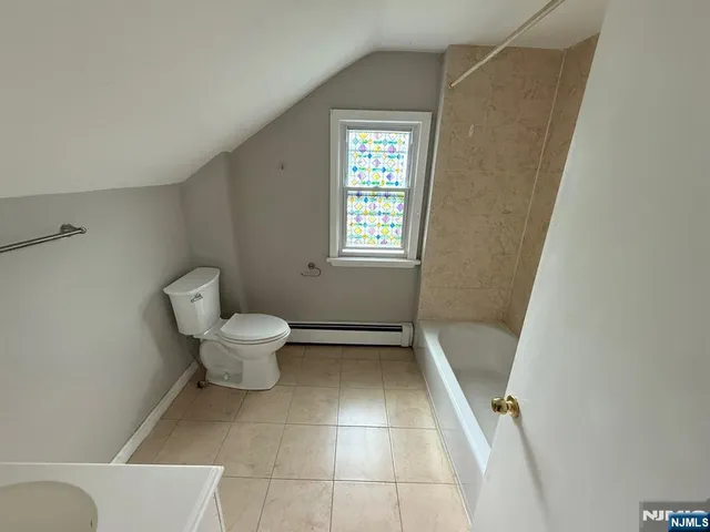 a bathroom with a toilet and a bath tub