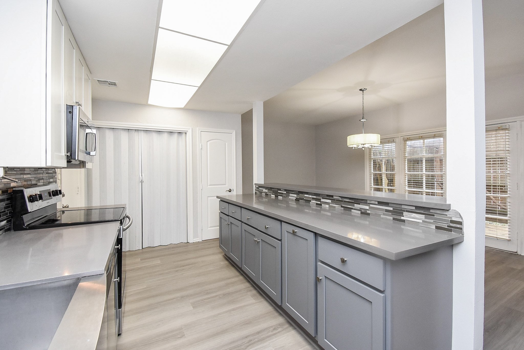 201 Vanderpool Lane, Unit 113 Houston, TX 77024 - Photo 19 of 45 a kitchen with a stove and a sink