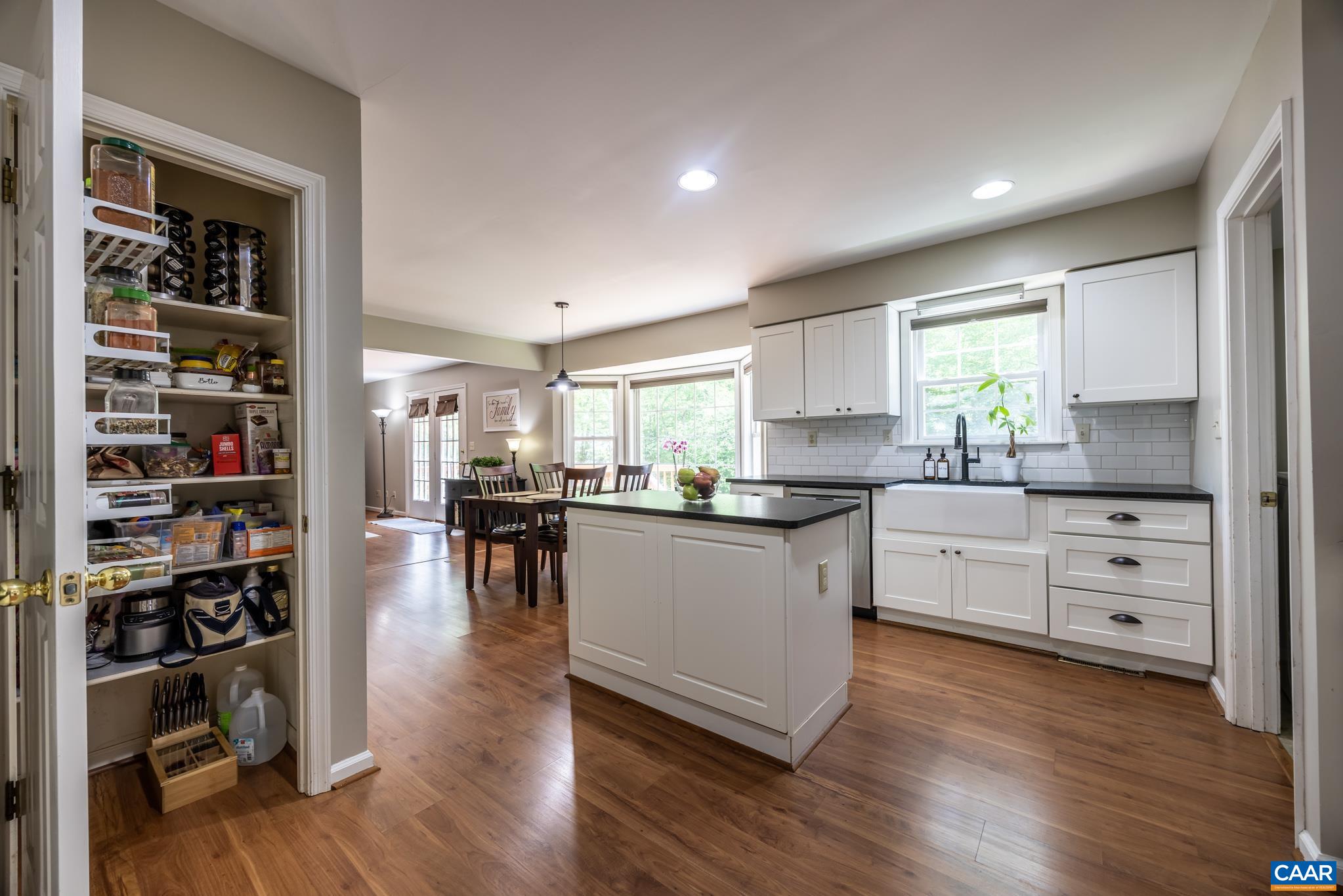 3221 Poplar Ridge Road Charlottesville, VA 22911 - Photo 15 of 72 a kitchen with white cabinets and wooden floor