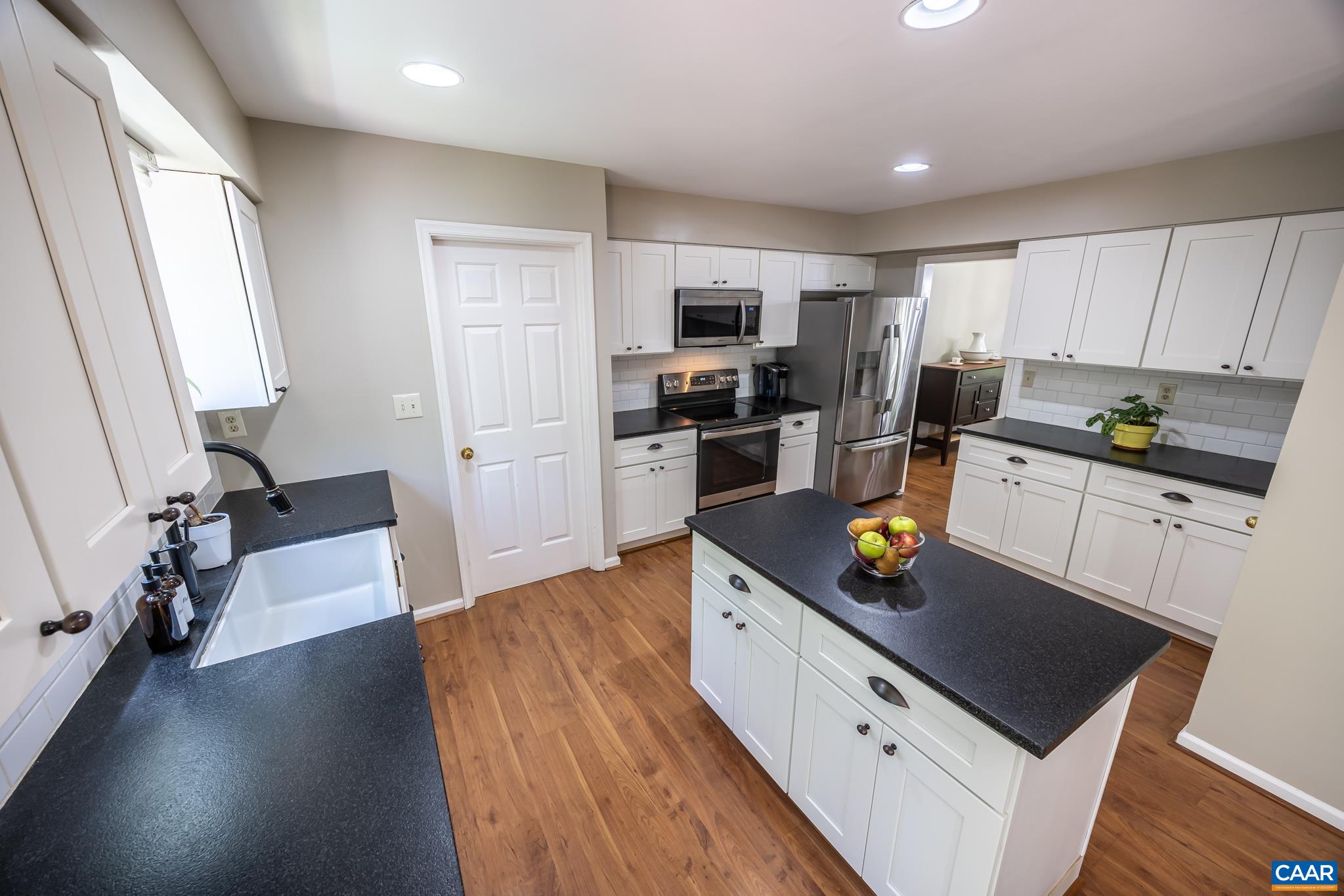 3221 Poplar Ridge Road Charlottesville, VA 22911 - Photo 16 of 72 a kitchen with granite countertop a sink appliances and cabinets