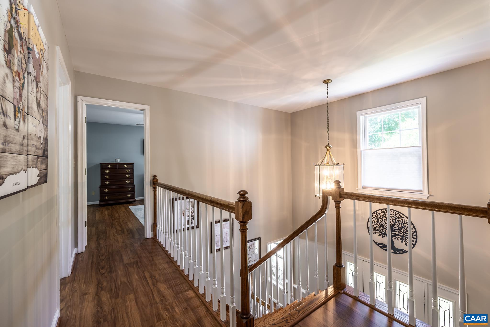 3221 Poplar Ridge Road Charlottesville, VA 22911 - Photo 23 of 72 a view of a hallway to a livingroom with wooden floor and stairs