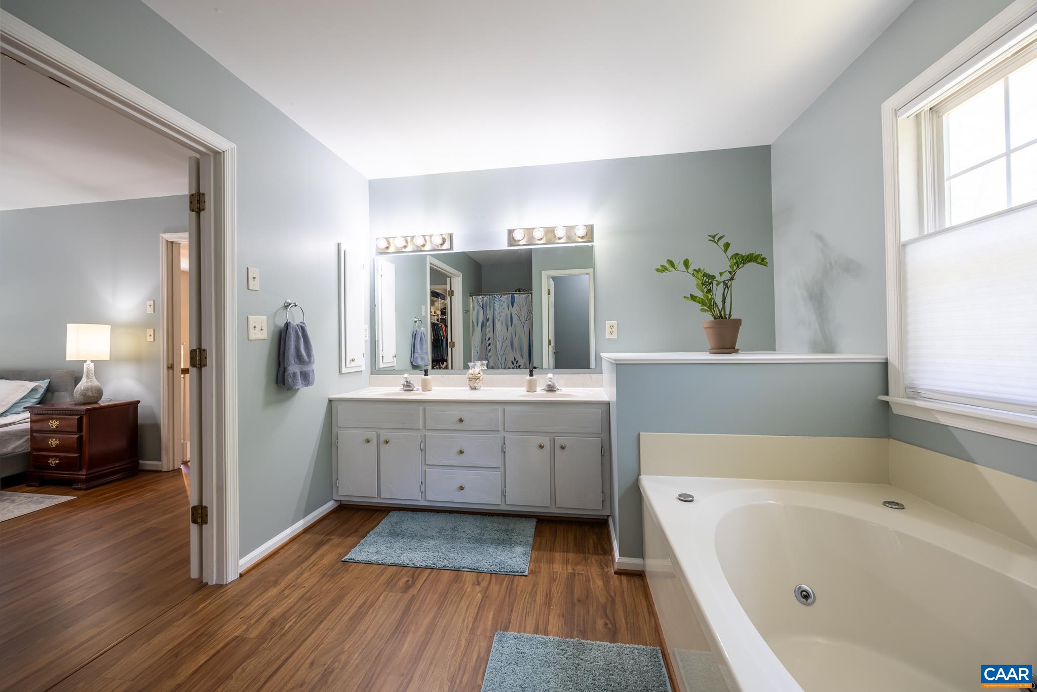 3221 Poplar Ridge Road Charlottesville, VA 22911 - Photo 30 of 72 a bathroom with a tub sink and mirror