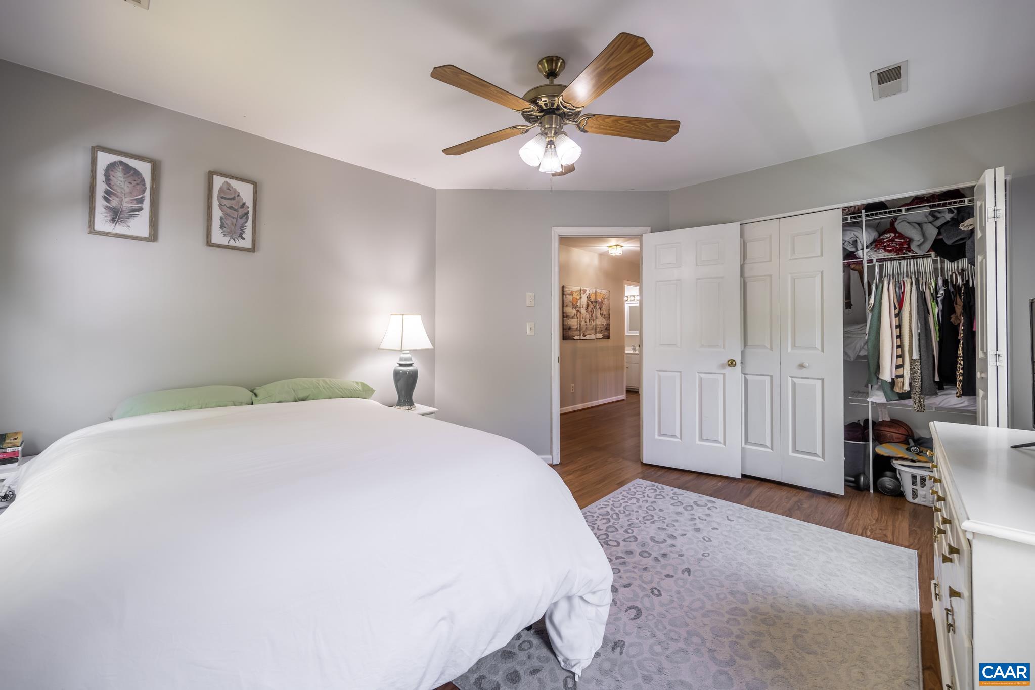 3221 Poplar Ridge Road Charlottesville, VA 22911 - Photo 32 of 72 a spacious bedroom with a bed and a chandelier
