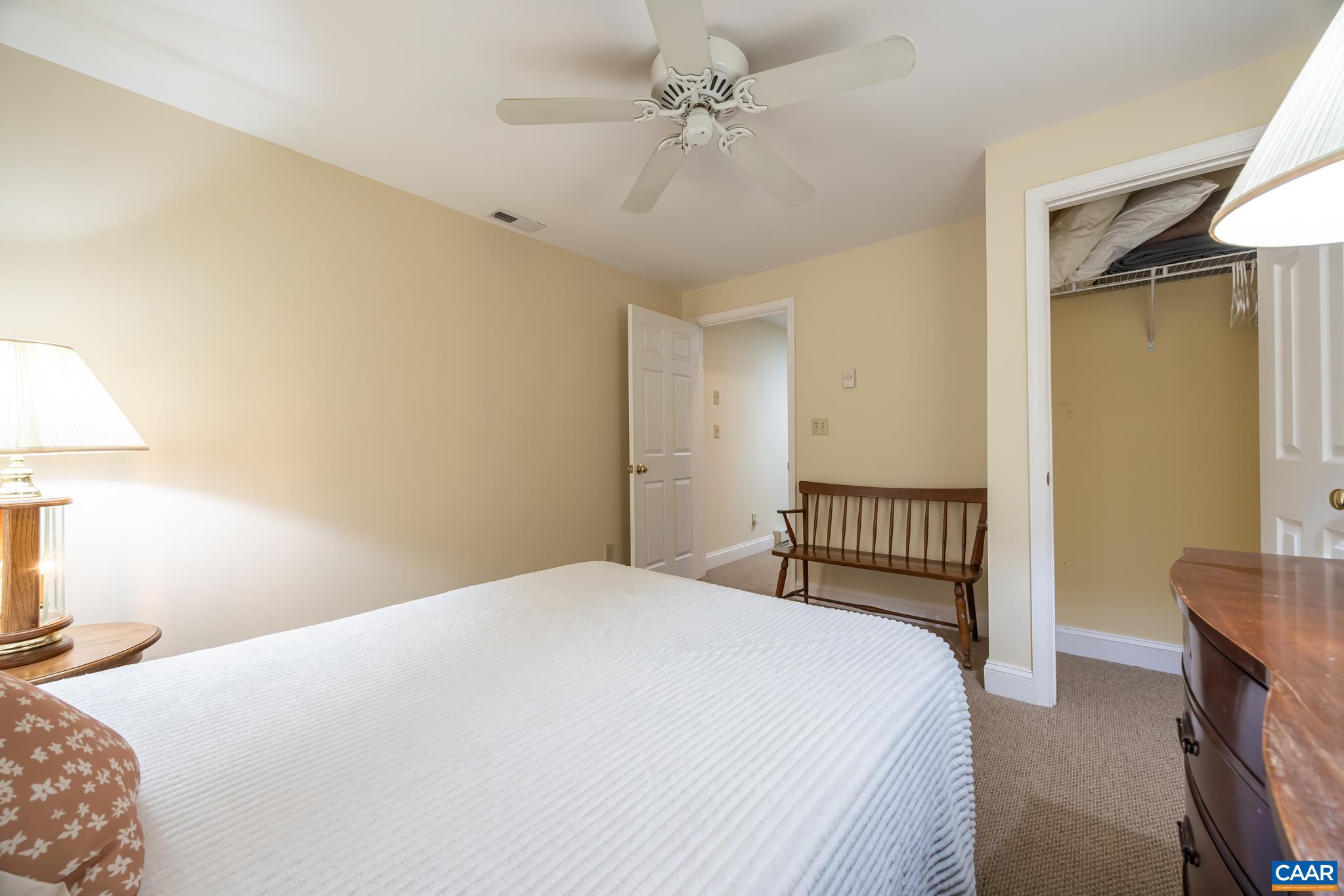 3221 Poplar Ridge Road Charlottesville, VA 22911 - Photo 43 of 72 a bedroom with a bed and a chandelier