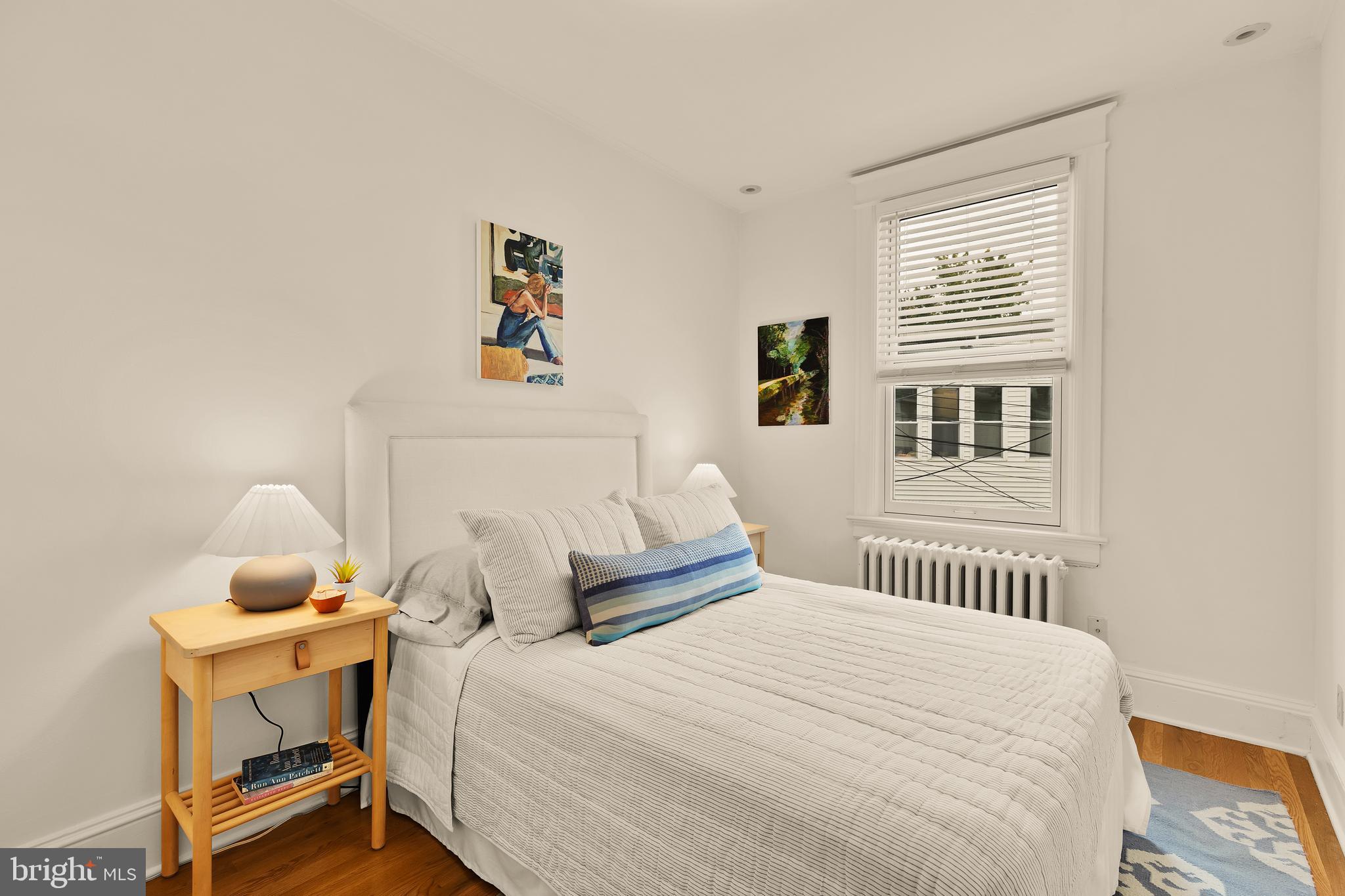 222 Tennessee Avenue Northeast Washington, DC 20002 - Photo 15 of 29 a bedroom with a bed and wooden floor