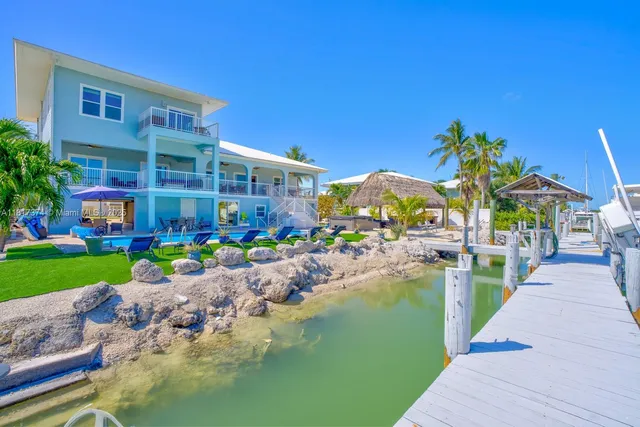 an aerial view of a house with a swimming pool yard and outdoor seating