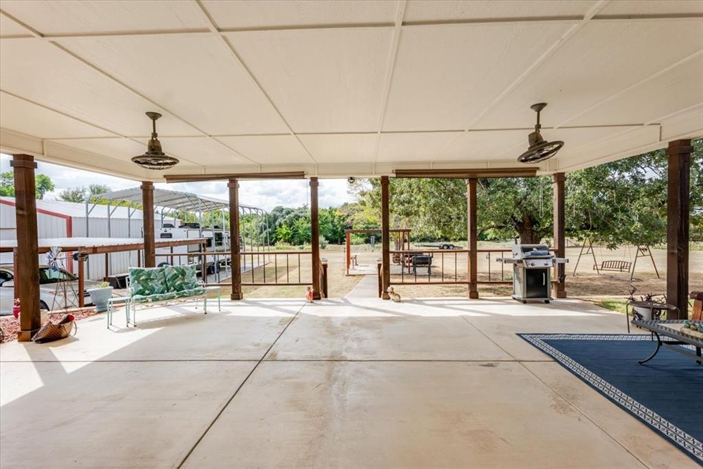 2400 Springfield Road Springtown, TX 76082 - Photo 21 of 31 Host gatherings or game night on this amazing covered back patio with fans and outdoor blinds