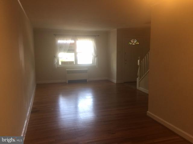 2808 16th Road South, Unit 2808B Arlington, VA 22204 - Photo 3 of 15 an empty room with wooden floor and windows with curtains
