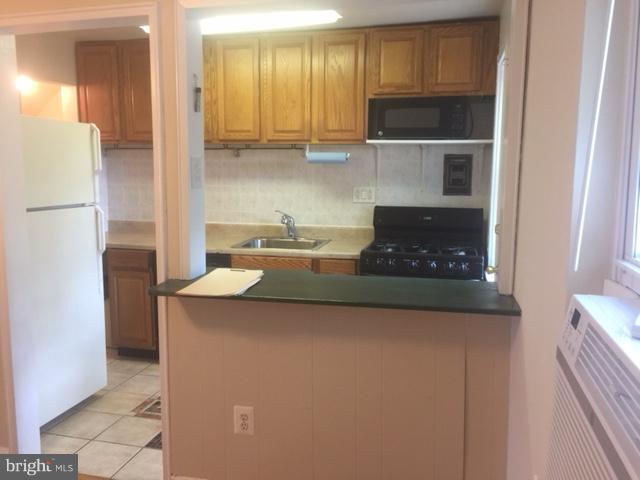 2808 16th Road South, Unit 2808B Arlington, VA 22204 - Photo 4 of 15 a kitchen with stainless steel appliances granite countertop a refrigerator and a stove top oven