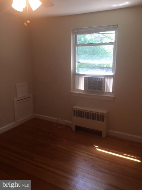 2808 16th Road South, Unit 2808B Arlington, VA 22204 - Photo 10 of 15 a view of an empty room with wooden floor and a window