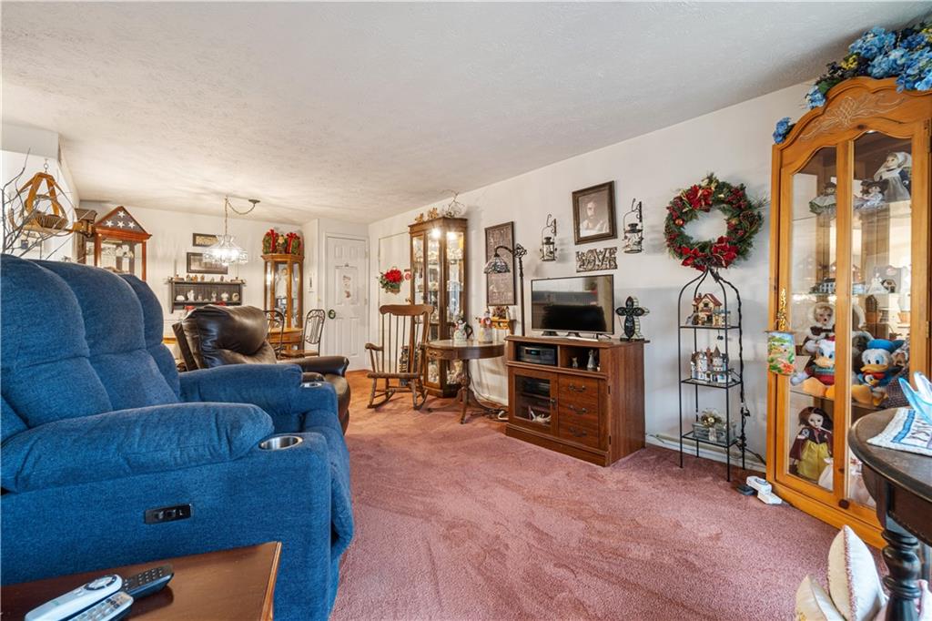 321 Ridge Point Circle, Unit 33B Bridgeville, PA 15017 - Photo 12 of 25 a living room with furniture and a flat screen tv