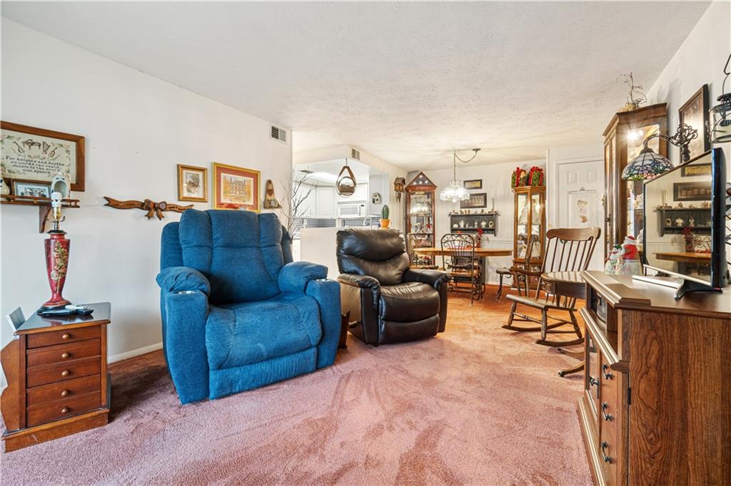 321 Ridge Point Circle, Unit 33B Bridgeville, PA 15017 - Photo 13 of 25 a living room with furniture and a flat screen tv
